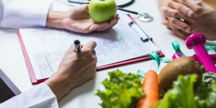 Nutritionist giving consultation to patient with healthy fruit and vegetable, Right nutrition and diet concept